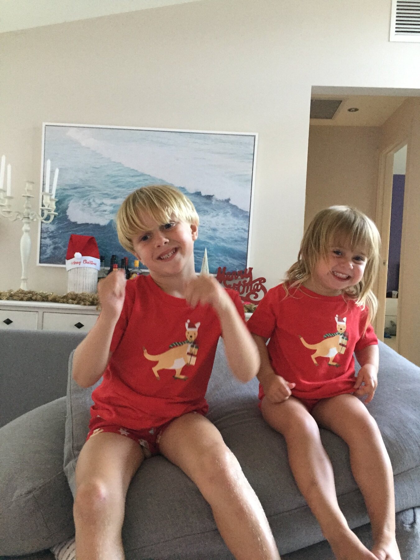 Flo and her brother smiling together at Christmas