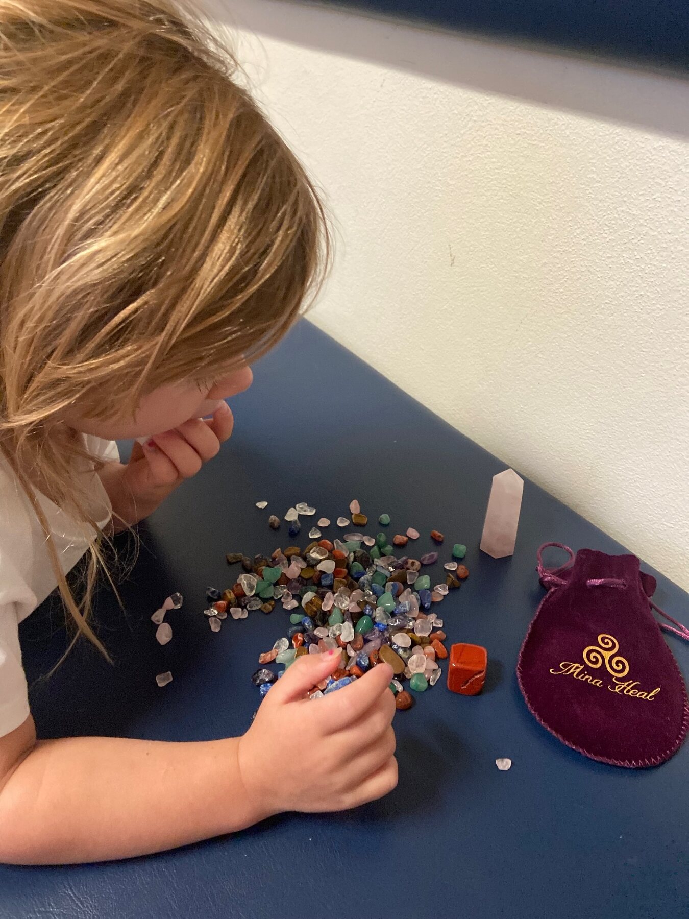 Flo carefully looking through her colourful crystals