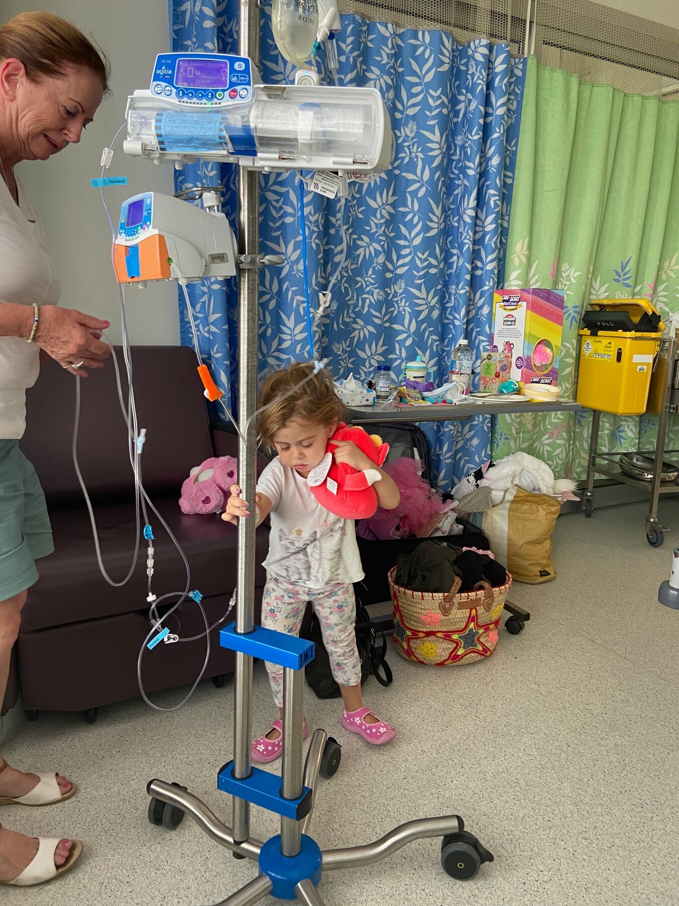 Flo in hospital receiving treatment with her favourite soft toys