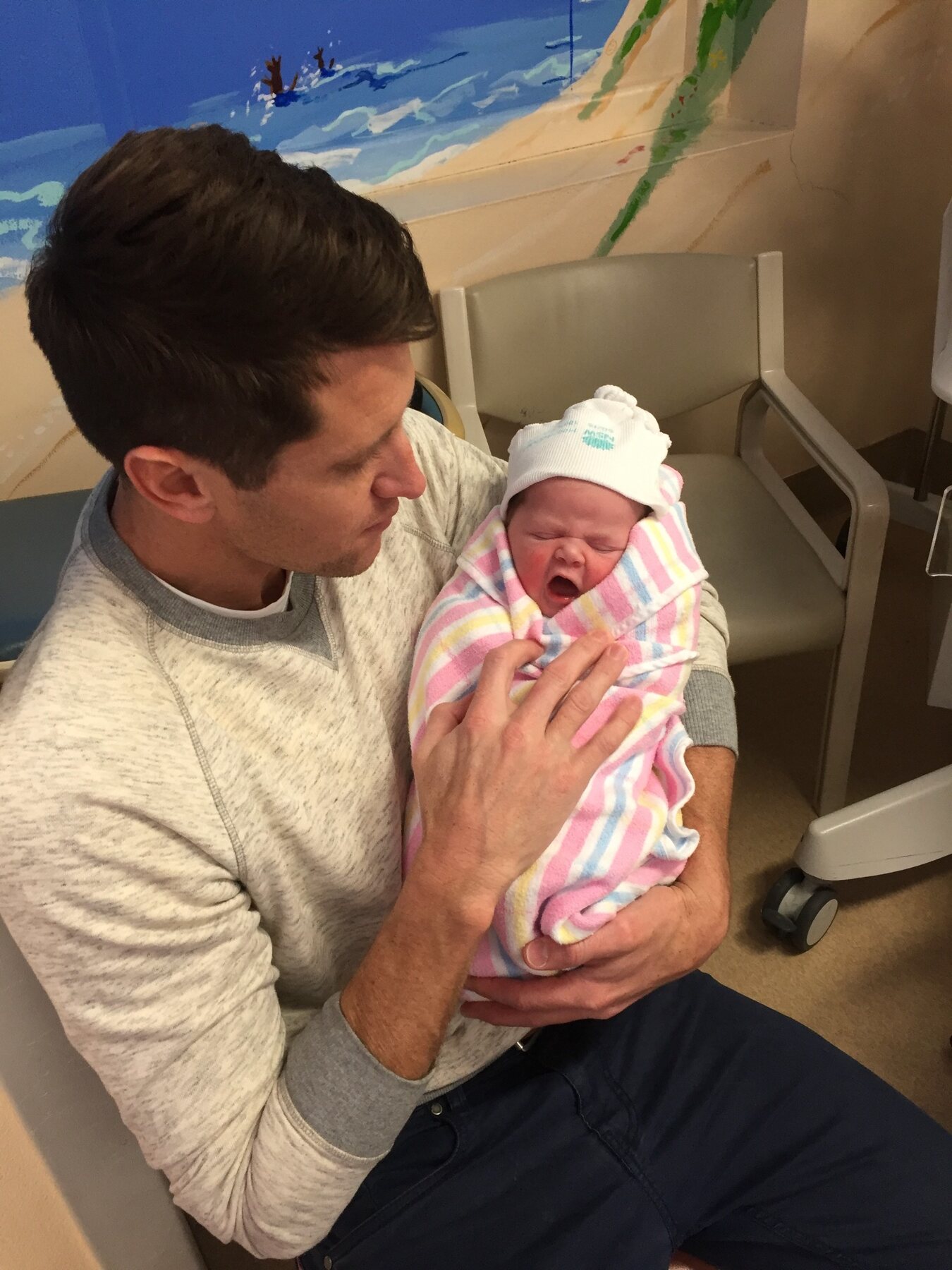 Newborn Flo being held by her dad