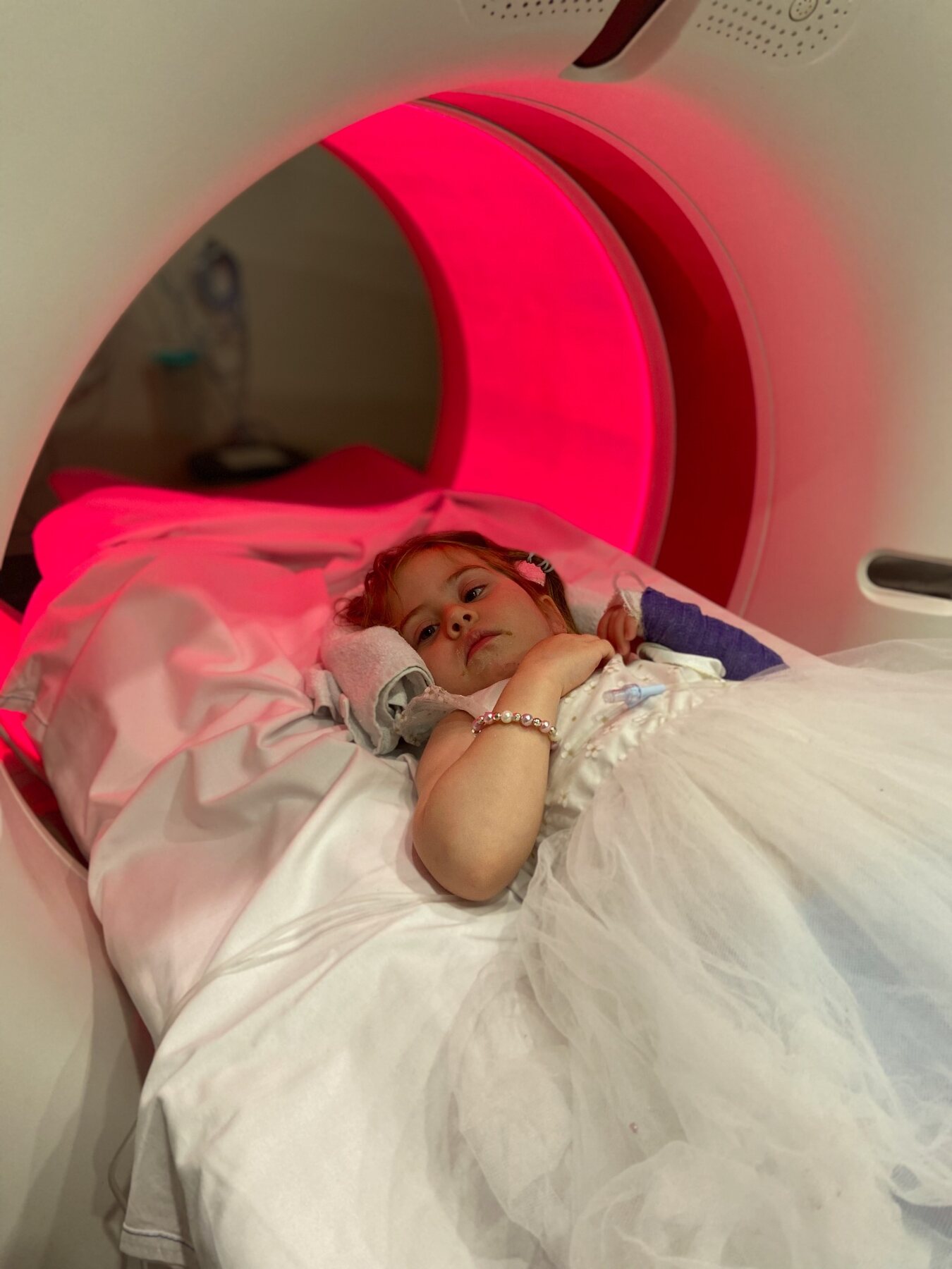 Flo lying calmly inside the radiation treatment machine