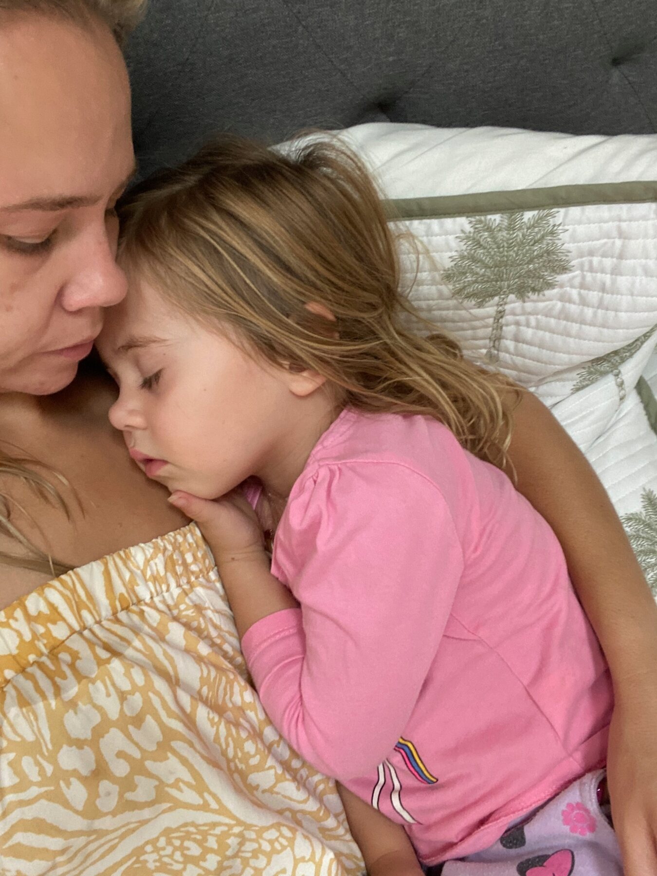 Flo sleeping safely in her mum’s arms